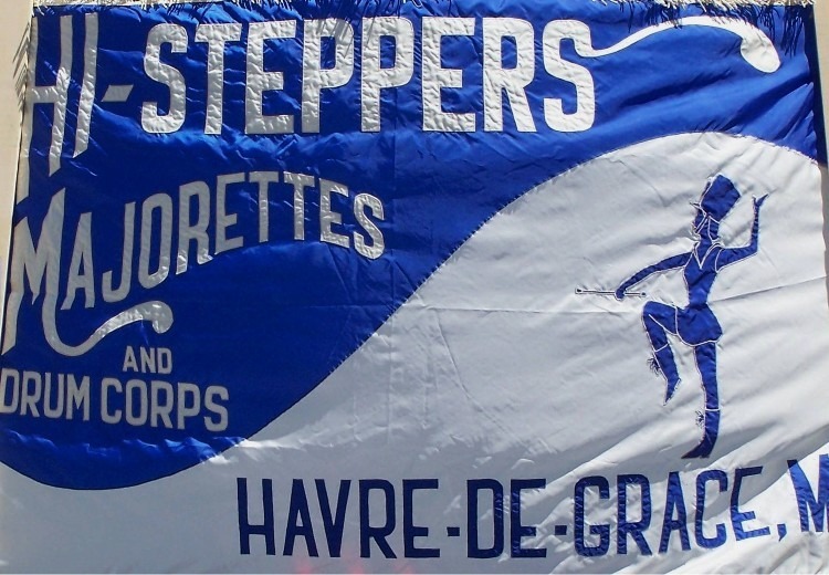 The blue and white flag of the Hi-Steppers Majorettes and Drum Corps of Havre de Grace MD.
