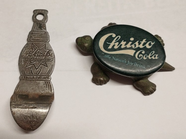 Vintage promotional items from Kelly Beverage of Havre de Grace - a Nu-Grape metal bottle opener and a tiny Christo Cola turtle