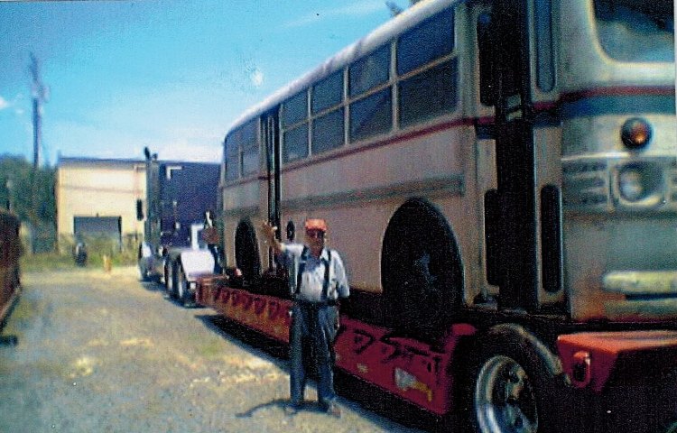 Mr. Vancherie next to a bus delivery at Inter-County Bus Lines in Havre de Grace, MD