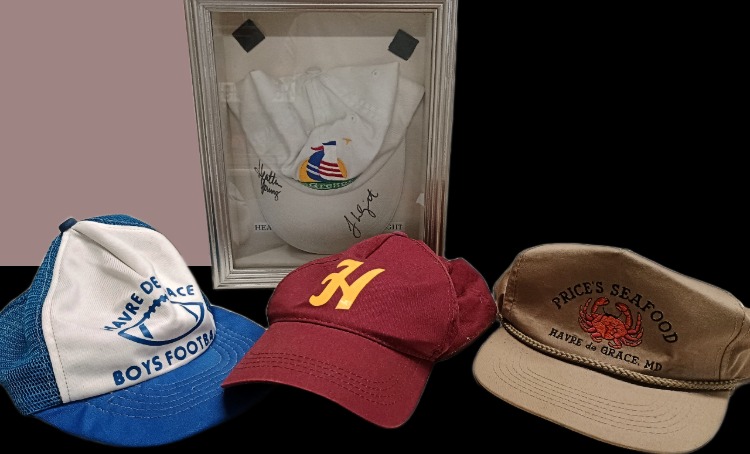 Variety of sports caps including Baseball and Football caps, a Price's Seafood cap (now Water Street Seafood) and an LPGA cap with autographs from Dan Lee of MacGregor's Restaurant - in the Havre de Grace History MuZeum at Bahoukas Antique Mall in Havre de Grace