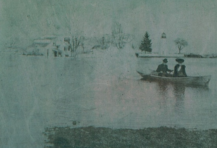 picture of the Keeper's House and Concord Point Lighthouse  with people in a rowboat. Thanks to Steve Lay sharing his father's, Ken, collection.